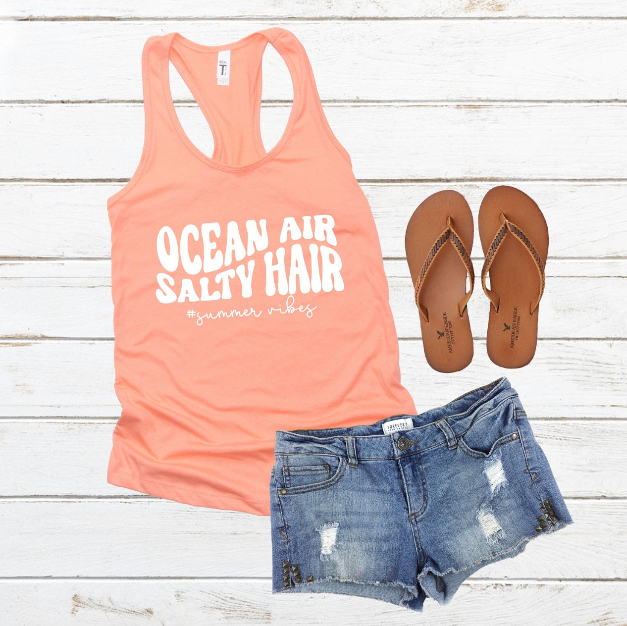 Ocean Air and Salty Hair racerback tank top in orange with white graphic