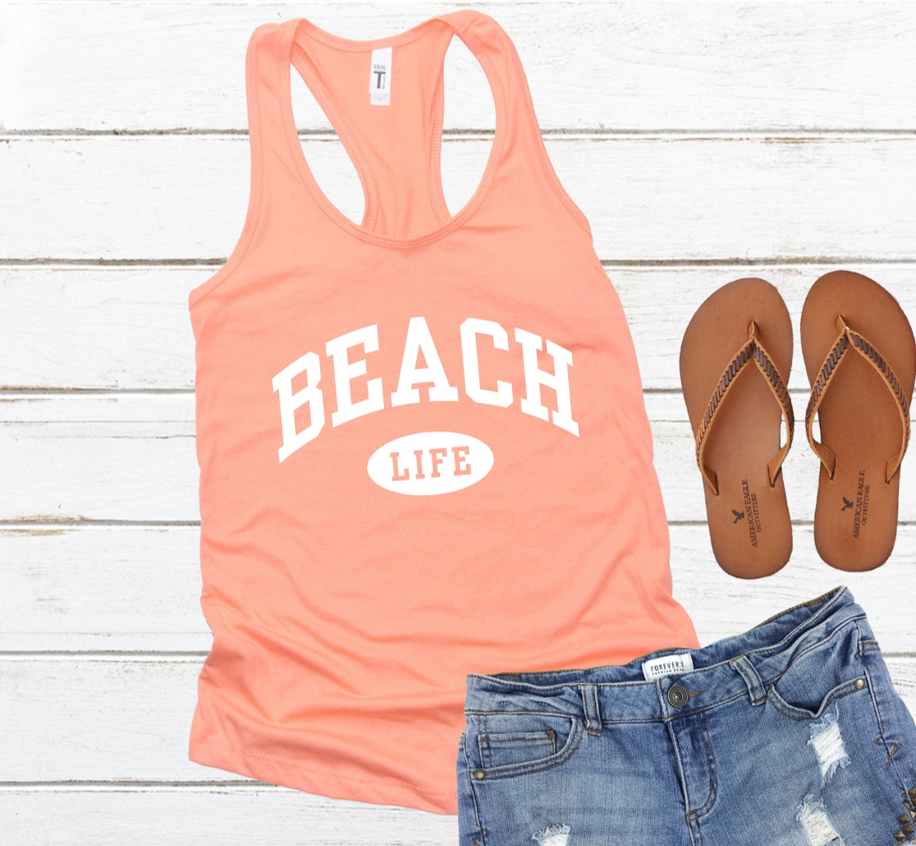 Beach life varsity print racerback tank top in orange with white graphic